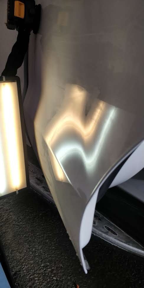 Door panel after paintless dent repair