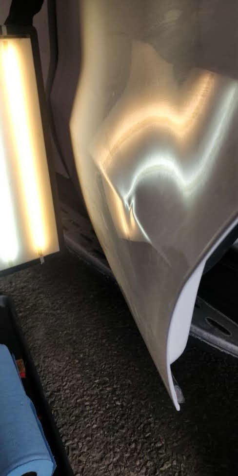 Door panel before paintless dent repair