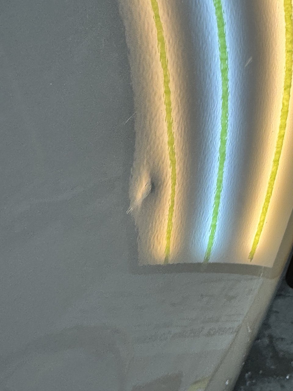 Silver panel dent before PDR repair