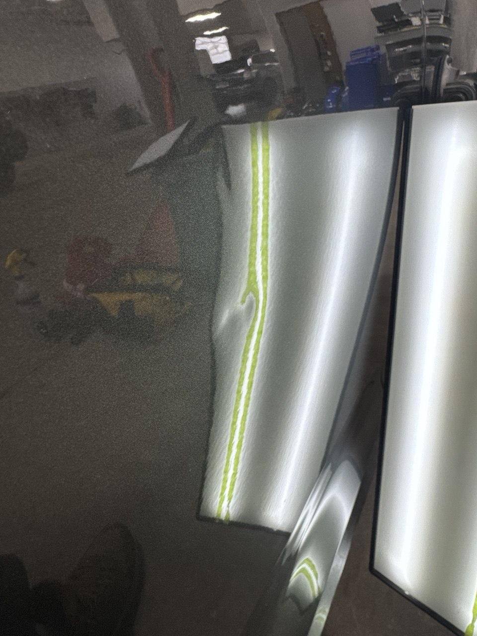 Fender dent before paintless dent repair